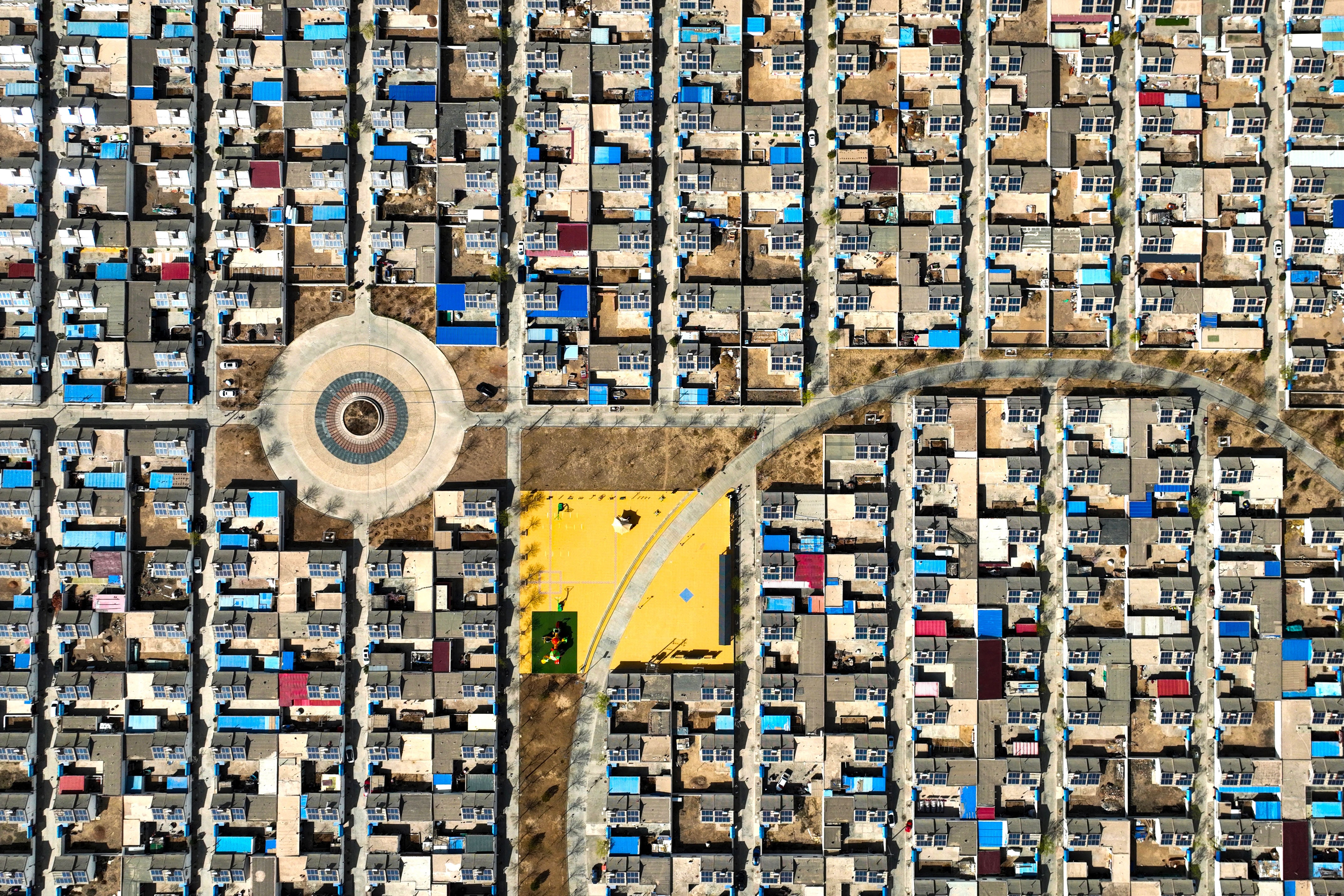 An aerial view of residential buildings with roof-mounted solar panels