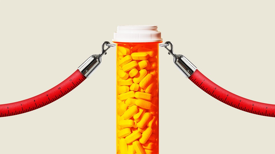 A bottle of pills acting as a stanchion, with two red-fabric tape measures hooked to it