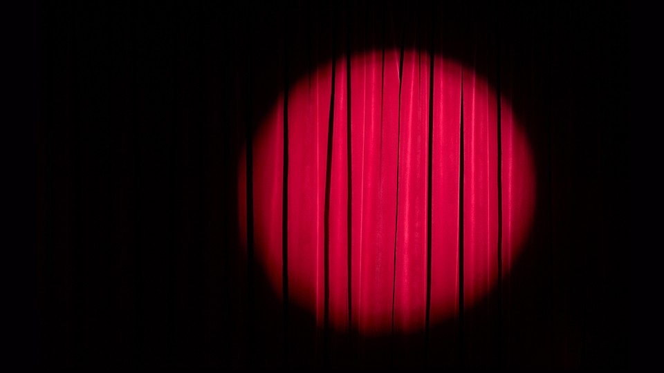 A spotlight on a red curtain