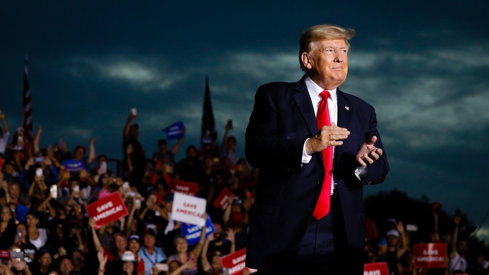 Donald Trump at a rally in Florida, with dark clouds in the background