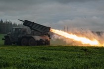 A rocket is launched from a truck-mounted multiple-rocket launcher.