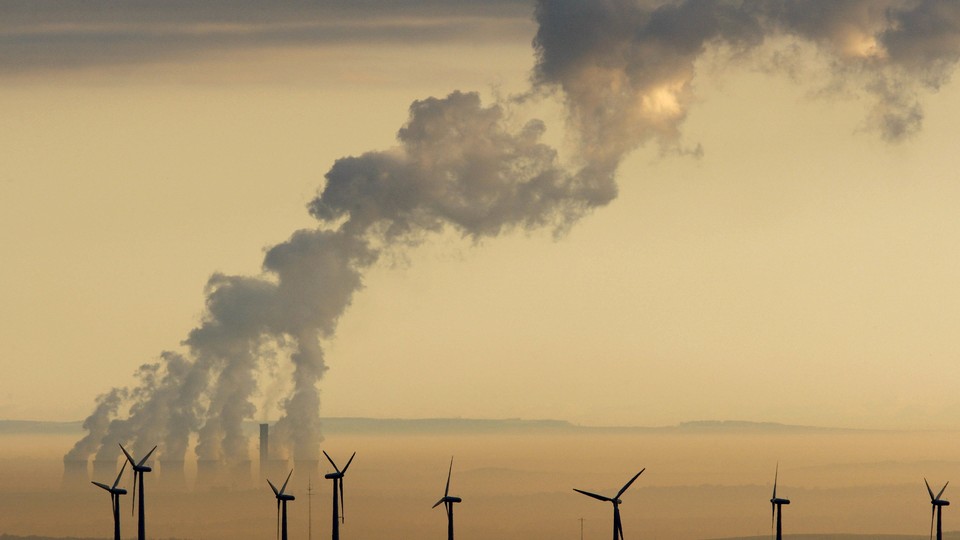 Smoke in the sky above windmills