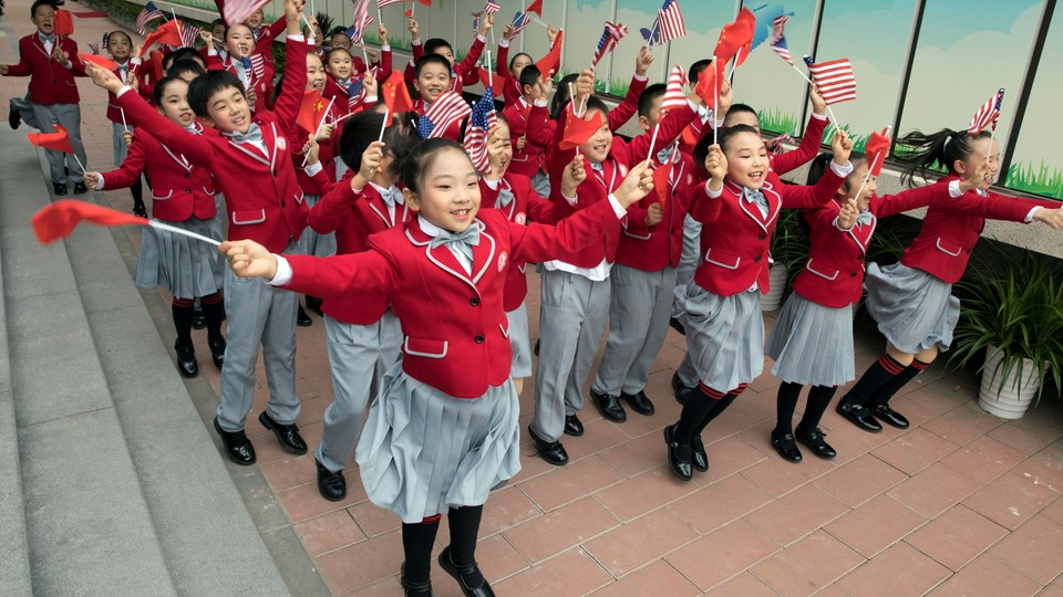 Chinese students wave U.S. and Chinese flags 