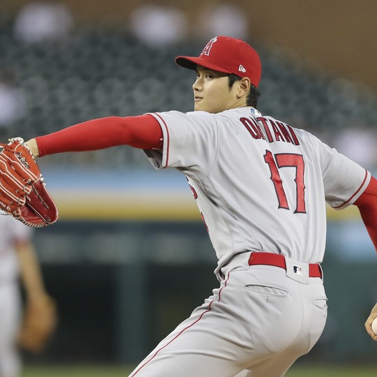 Los Angeles Angels' Shohei Ohtani wears thick protective gloves as he  occupies first base after drawing a walk during the fifth inning of a  baseball game against the Chicago White Sox Tuesday
