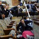 People shelter in the House gallery as protesters try to break into the House Chamber at the U.S. Capitol on Wednesday, Jan. 6, 2021, in Washington.