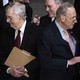 Mitch McConnell and Chuck Schumer stand back-to-back.