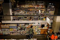 A customer in front of many stocked aisles at a Whole Foods