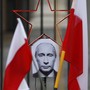 A photo of Russian President Vladimir Putin between two Polish flags