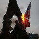 Iranians burn U.S. and Israeli flags.