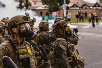 A photo of military personnel deployed to a scene of civil unrest