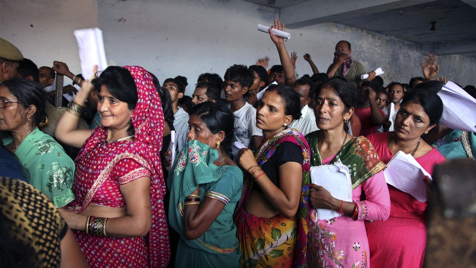 Indian Hindu devotees stand in a queue to register for a pilgrimage to the Hindu holy site of Amarnath on July 2, 2015. 