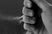 A hand with dust falling through its fingers