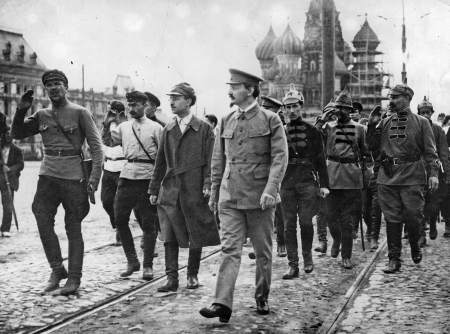 Several men in uniform walk together in Moscow's Red Square.
