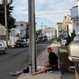 A woman crouches on the sidewalk next to her boyfriend, who is unresponsive and not breathing after an opioid overdose in the Boston suburb of Everett, Massachusetts, on August 23, 2017.