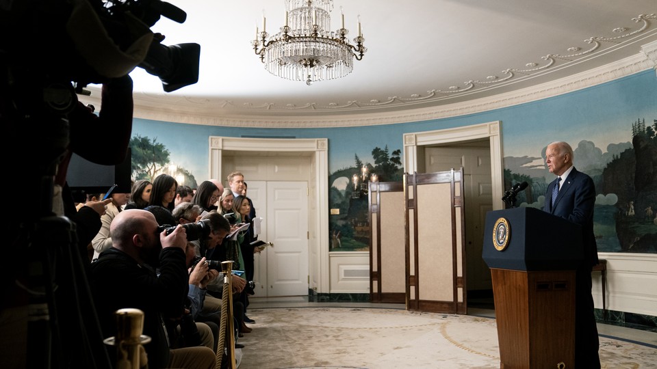 President Joe Biden at a press conference in front of many cameras and reporters