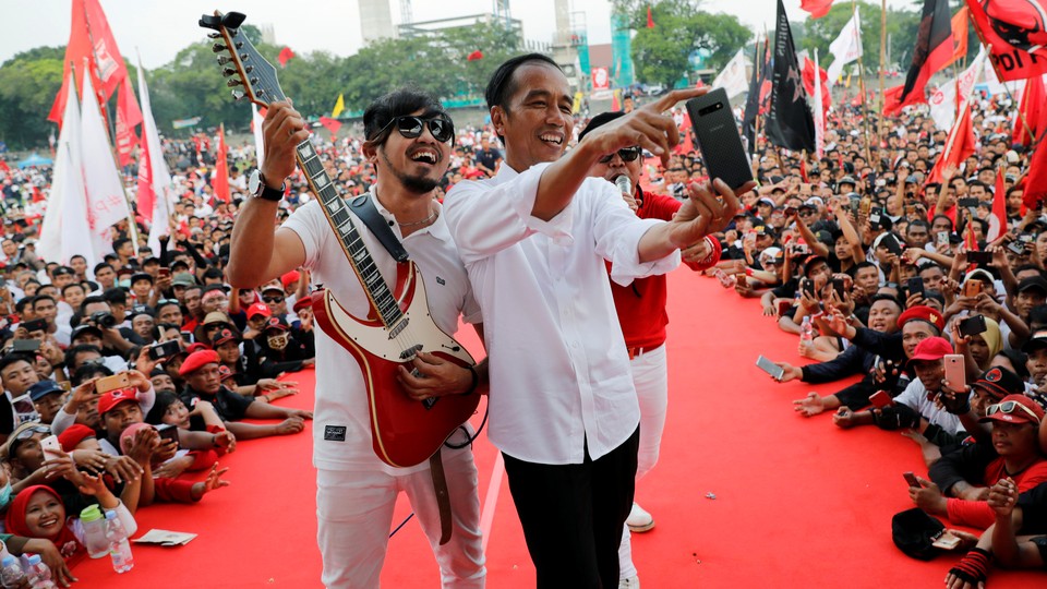 Indonesia's incumbent president, Joko Widodo, poses for a selfie ahead of elections this week.