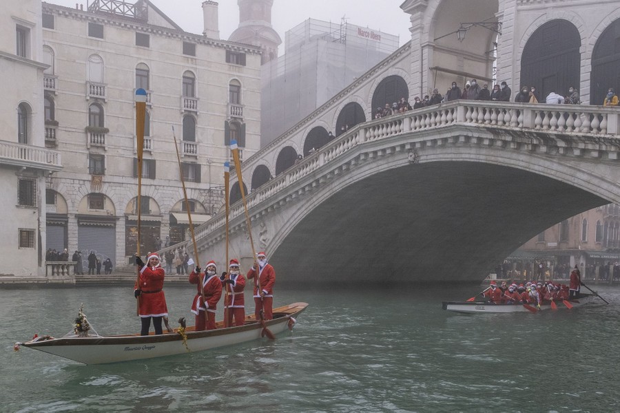 Rowers dressed as Santa Claus take part in a regatta on the Grand Canal in Venice.