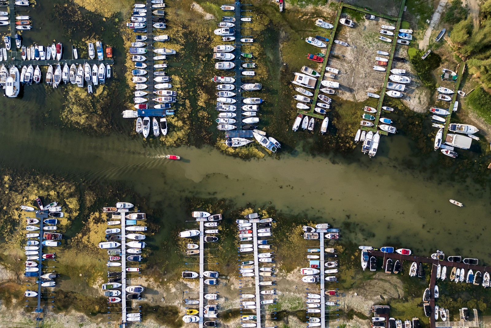 An aerial photo shows boats in a marina left stranded on a dry riverbed.