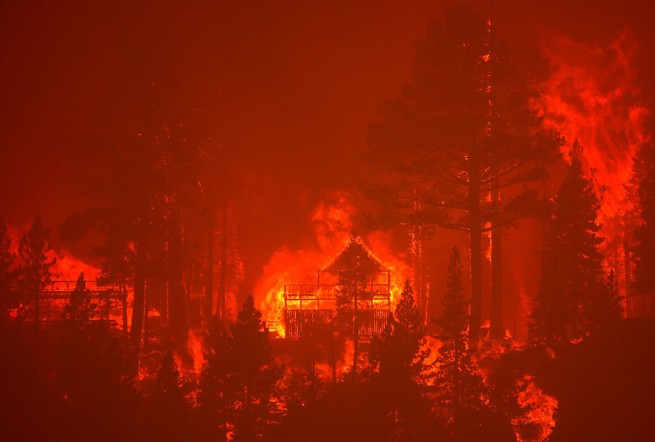 The Caldor Fire burns homes along a ridge on August 30, 2021, near South Lake Tahoe.