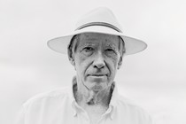 black-and-white photo of Ian McEwan wearing straw fedora and white collared shirt