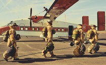 Smoke jumpers in gear boarding a plane