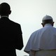 the back of Barack Obama standing next to Pope Francis