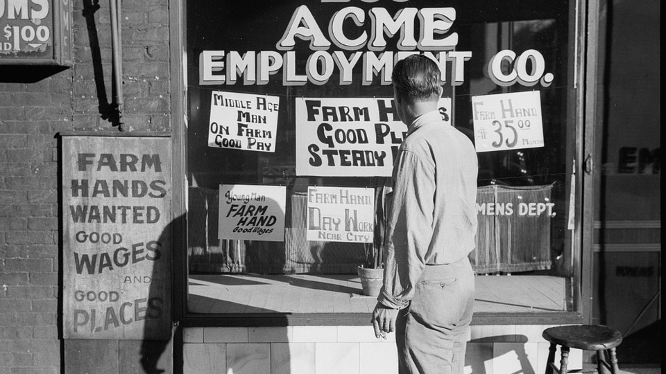 A man stands in front of employment signs