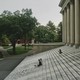 Side picture of the stairs that lead to building with greek columns in college campus.