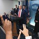 Donald Trump at the podium of the White House briefing room during a press conference