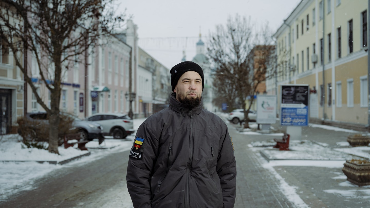 Photo of a man standing in a wintry street
