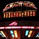 A gravitron ride at a carnival at night