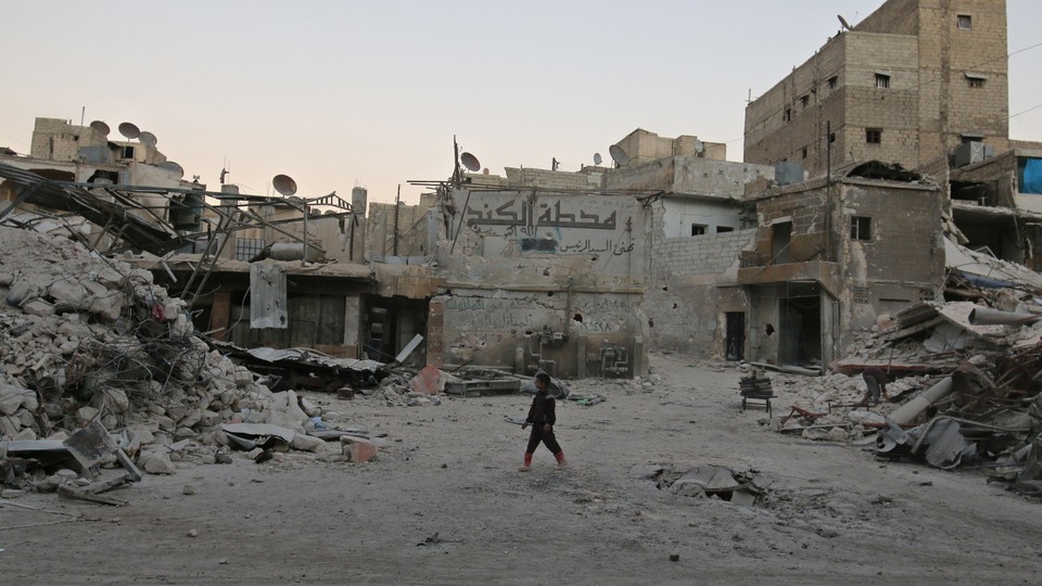 A boy walks amid damaged buildings in the rebel held area of al-Kalaseh neighbourhood of Aleppo.