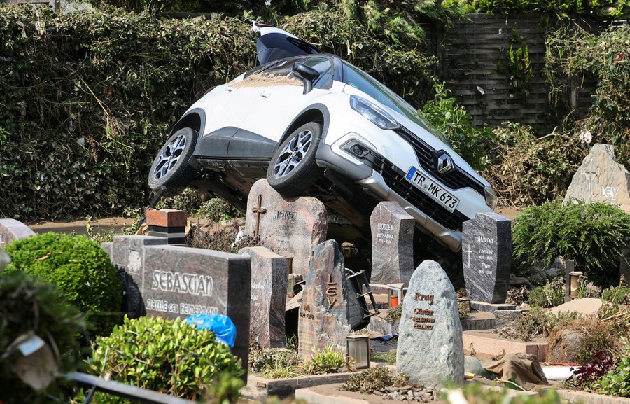 A car rests in a cemetery following flooding.