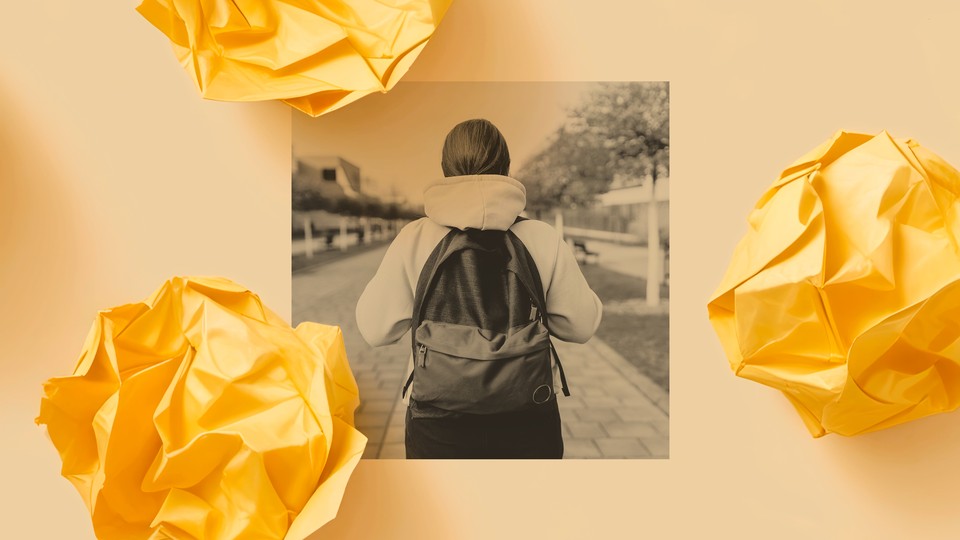 A student walks outside wearing a backpack