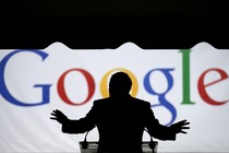 Georgia Governor Nathan Deal speaks silhouetted in front of a large screen that says "Google."