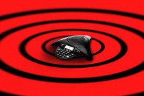 An illustration of concentric circles centered around a conference call microphone.