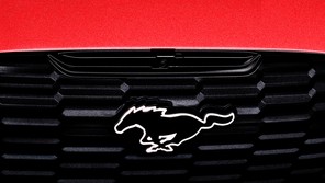 the front bumper of a Ford Mustang Mach-E, showing the galloping-horse logo