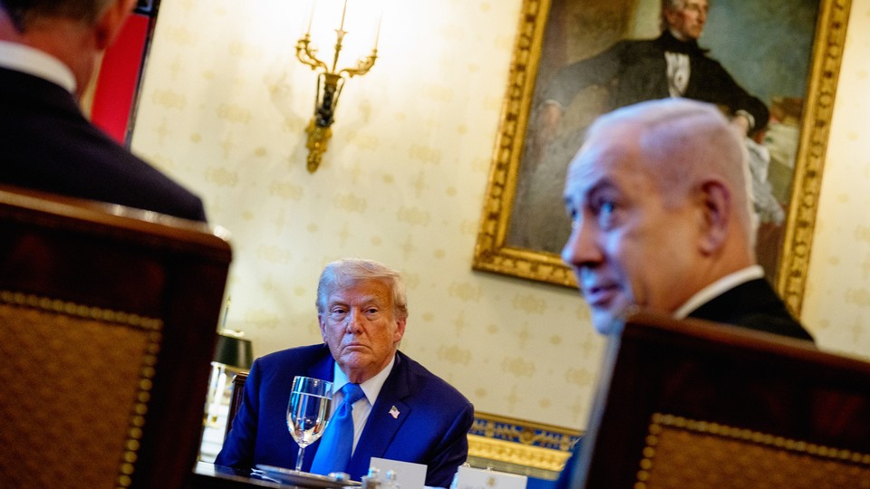 Trump sitting in conference table with Netanyahu and others
