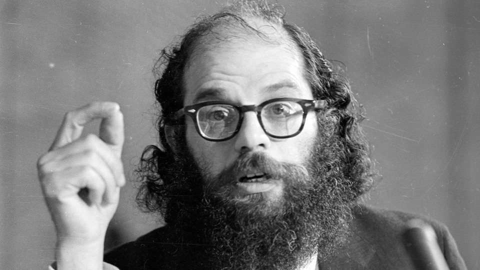 photo of author in suit and glasses speaking at microphone