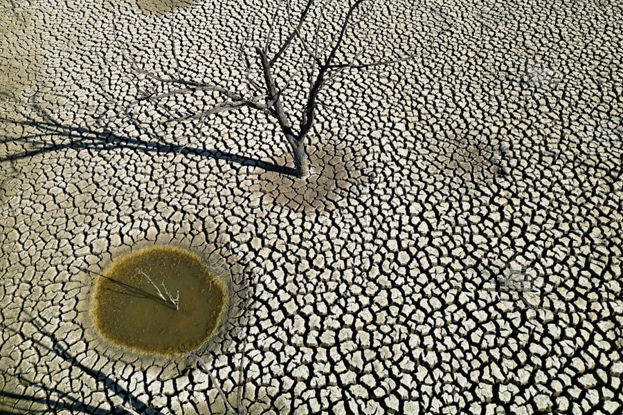 An elevated view of the cracked mud of a dry reservoir basin