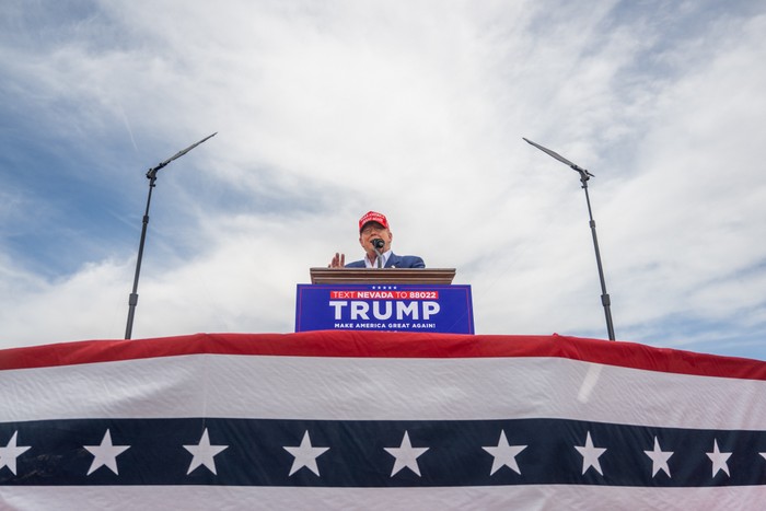 Donald Trump speaks from a podium during his campaign rally