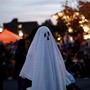 A man in a ghost costume marches in the annual Nyack Halloween Parade, in October 2016.