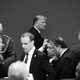 Black-and-white photo of Donald Trump in a roomful of people