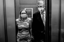 A black-and-white photo of Joe Manchin and Kyrsten Sinema in a Capitol Hill elevator