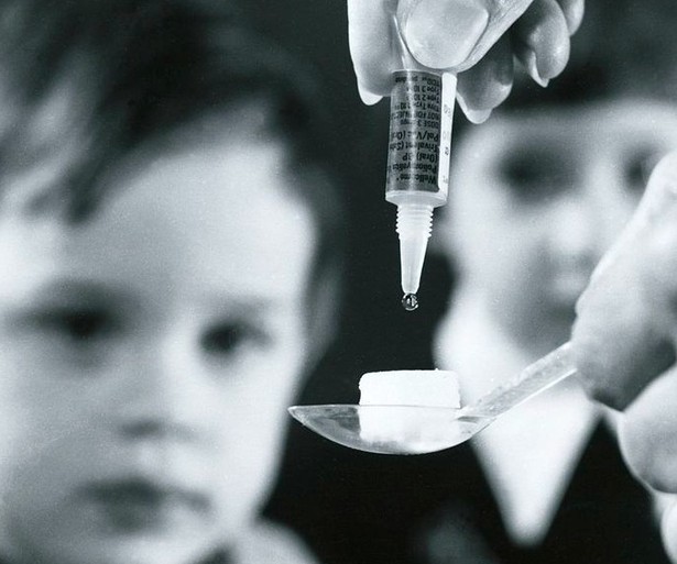 kicker Health Polio vaccine is dropped onto a sugar cube for a young