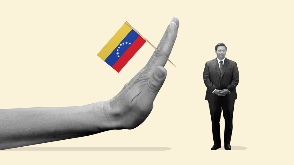 A hand holding a Venezuelan flag and threatening to smash miniature of Ron DeSantis.
