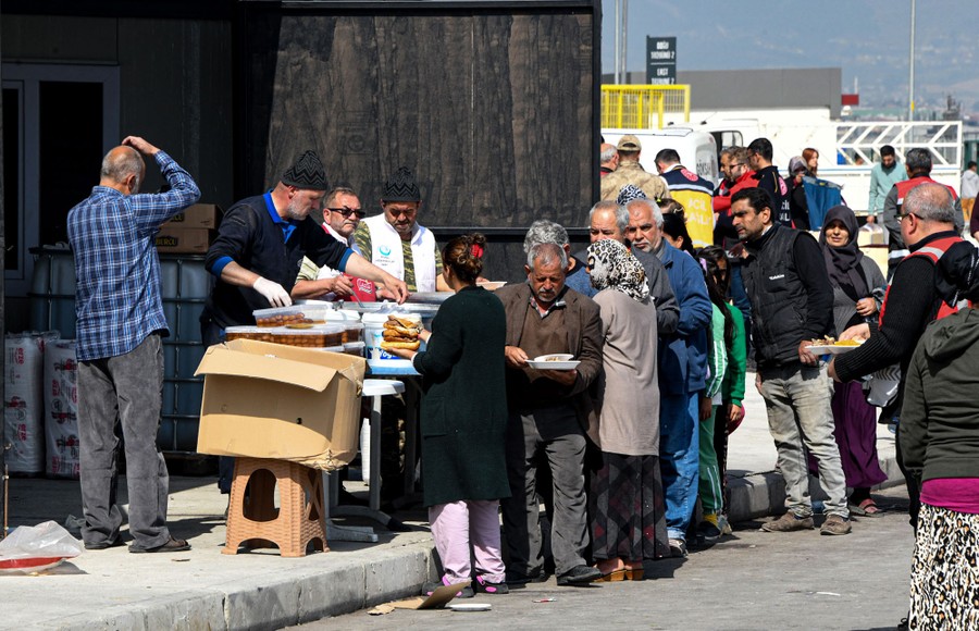 People line up for food handouts.