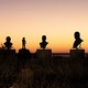 Photo of silhouettes of busts on pedestals during sunset