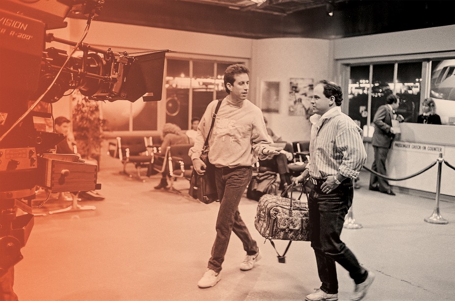 photo of Jerry Seinfeld and Jason Alexander walking and talking on set with cameras