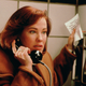 Color film still of Catherine O'Hara at a payphone in "Home Alone."